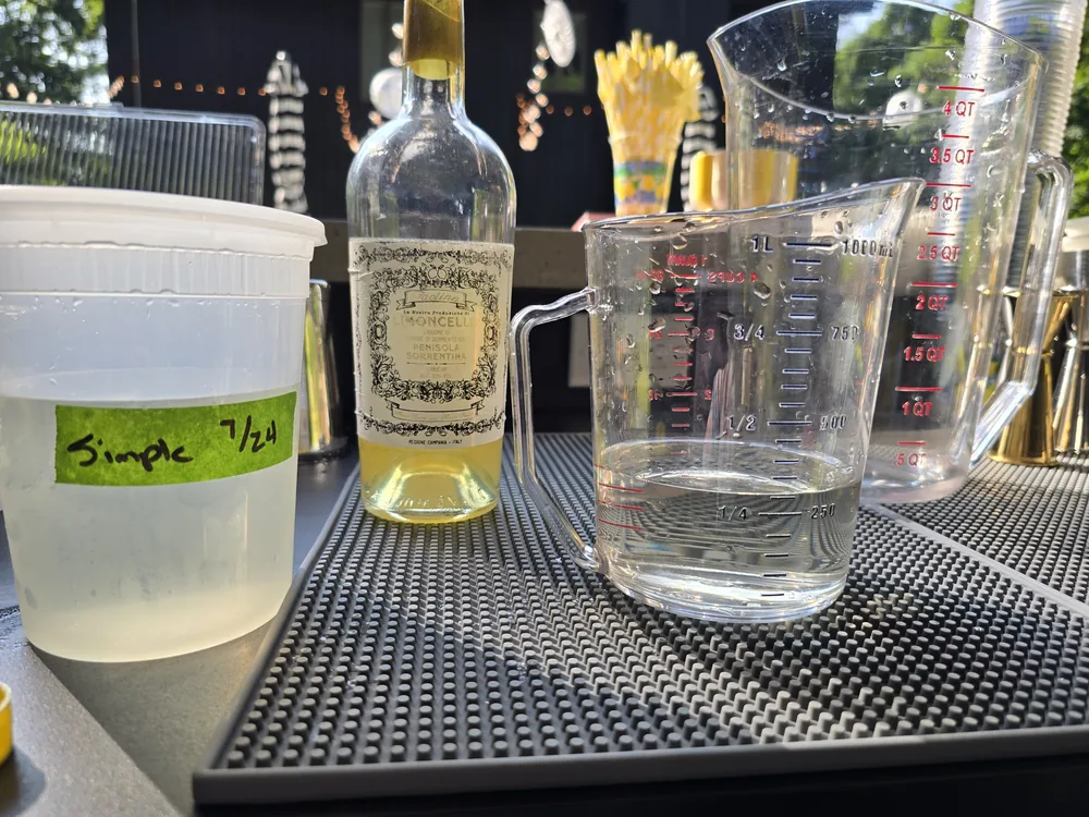 House-made simple syrup, dated and labelled, prepped the day before a private event